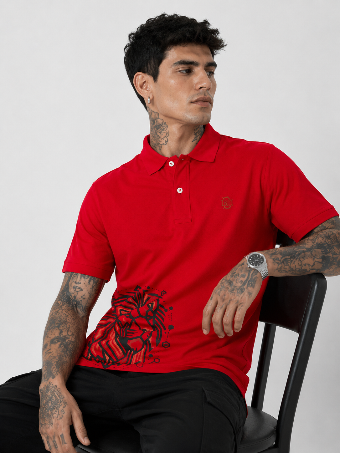 Red Lion red polo shirt with lion graphic on chest and buttoned collar