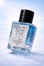 Eau de Parfum bottle, blue-tinted liquid, black cap, 50ml, label facing left