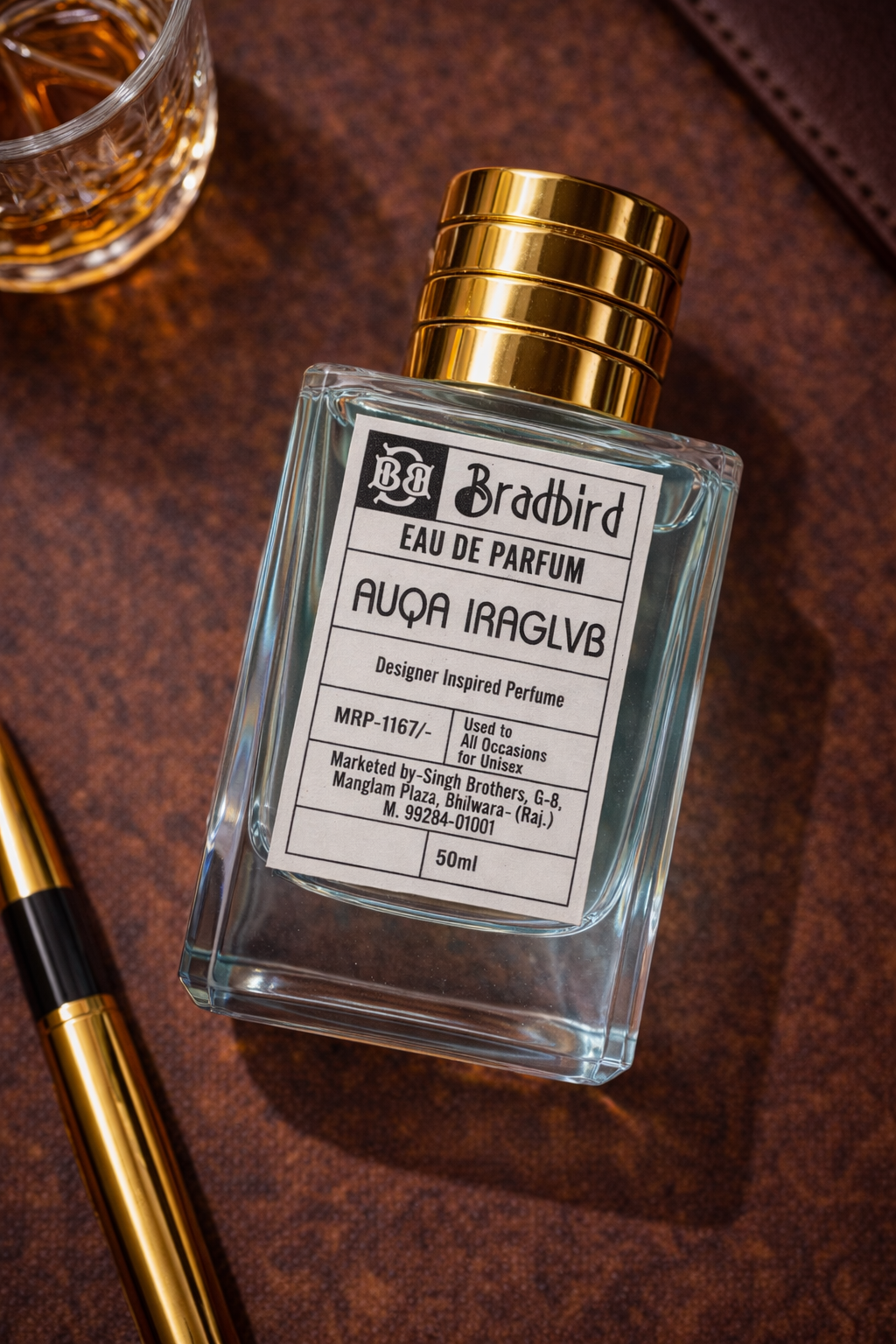 Eau de Parfum bottle with gold cap, front label, beside gold pen, 50ml