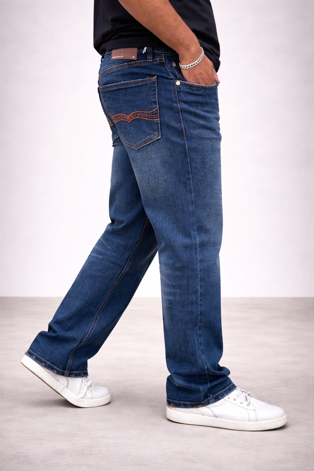 Blue denim straight jeans with embroidered back pockets and dark stitched seams