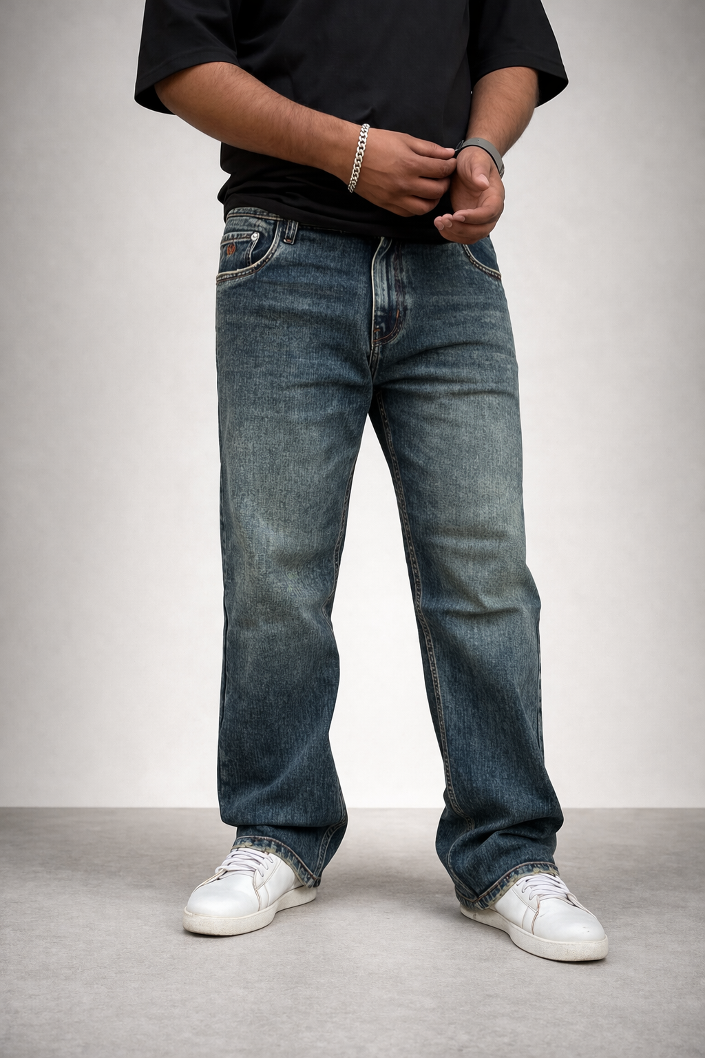 Straight-leg jeans in vintage indigo wash, front-side view, cuffed hem