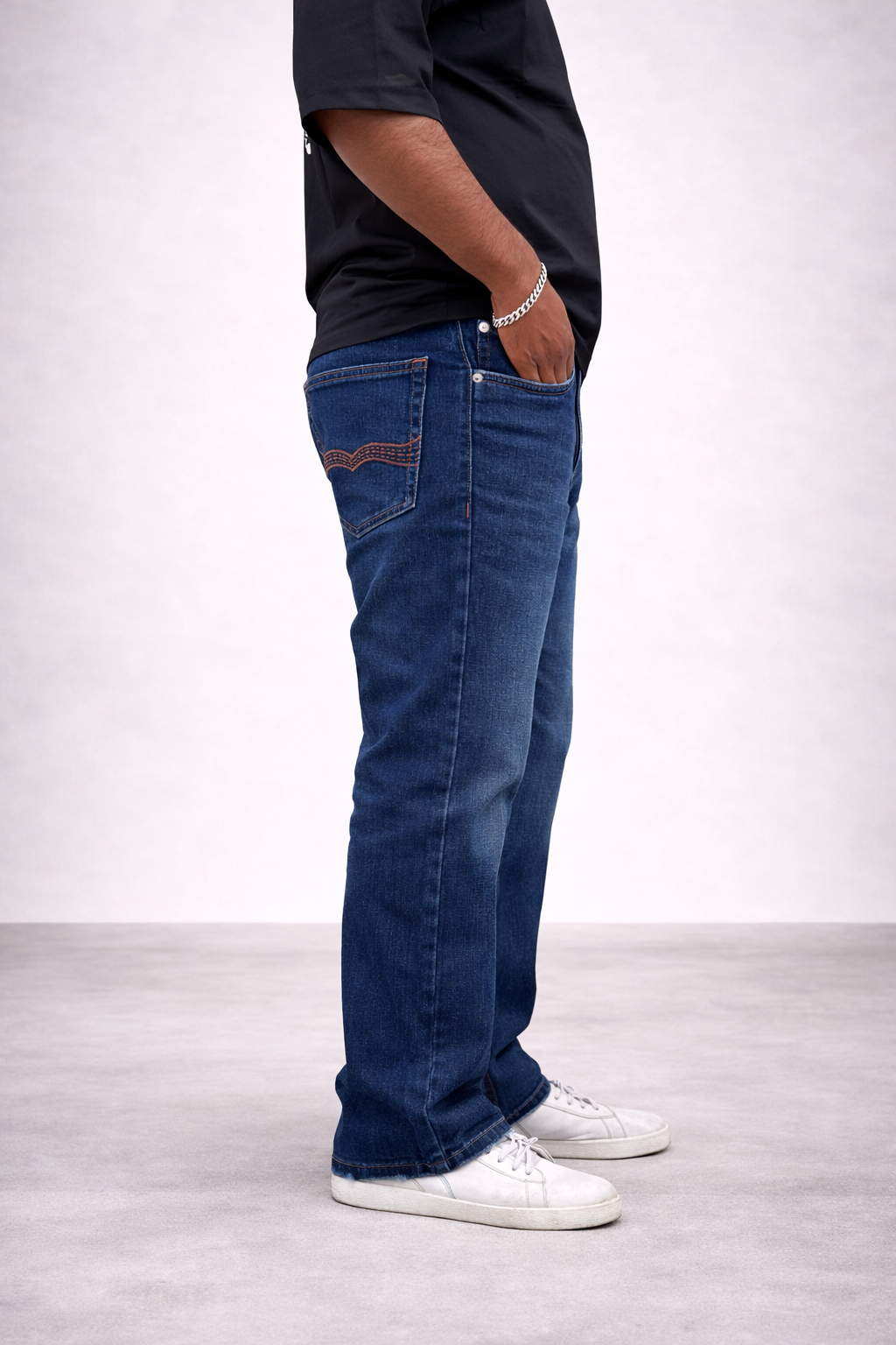 Straight jeans side view in indigo stone wash, single front pocket stitching