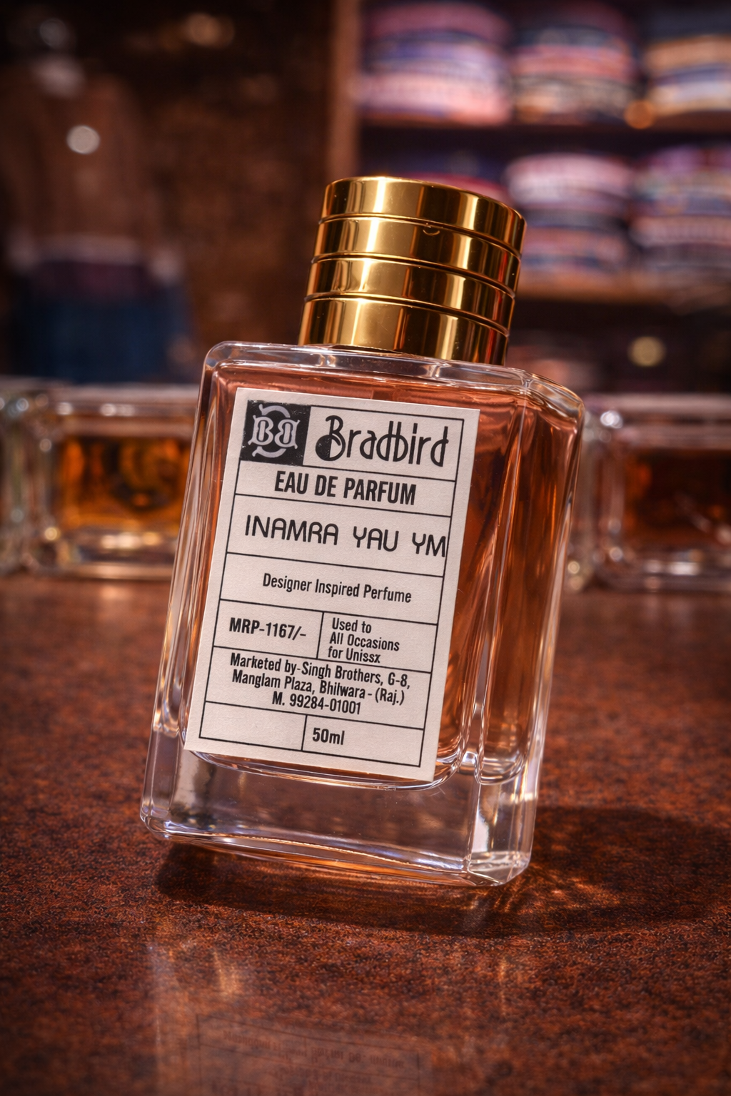 Inamra Yau YM Eau de Parfum 50ml bottle, angled view, gold cap and label panel