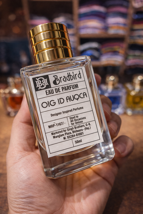 Unisex eau de parfum 50ml bottle in hand, angled front label, gold cap