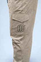 Beige cargo joggers with flap side pocket and '05' printed patch