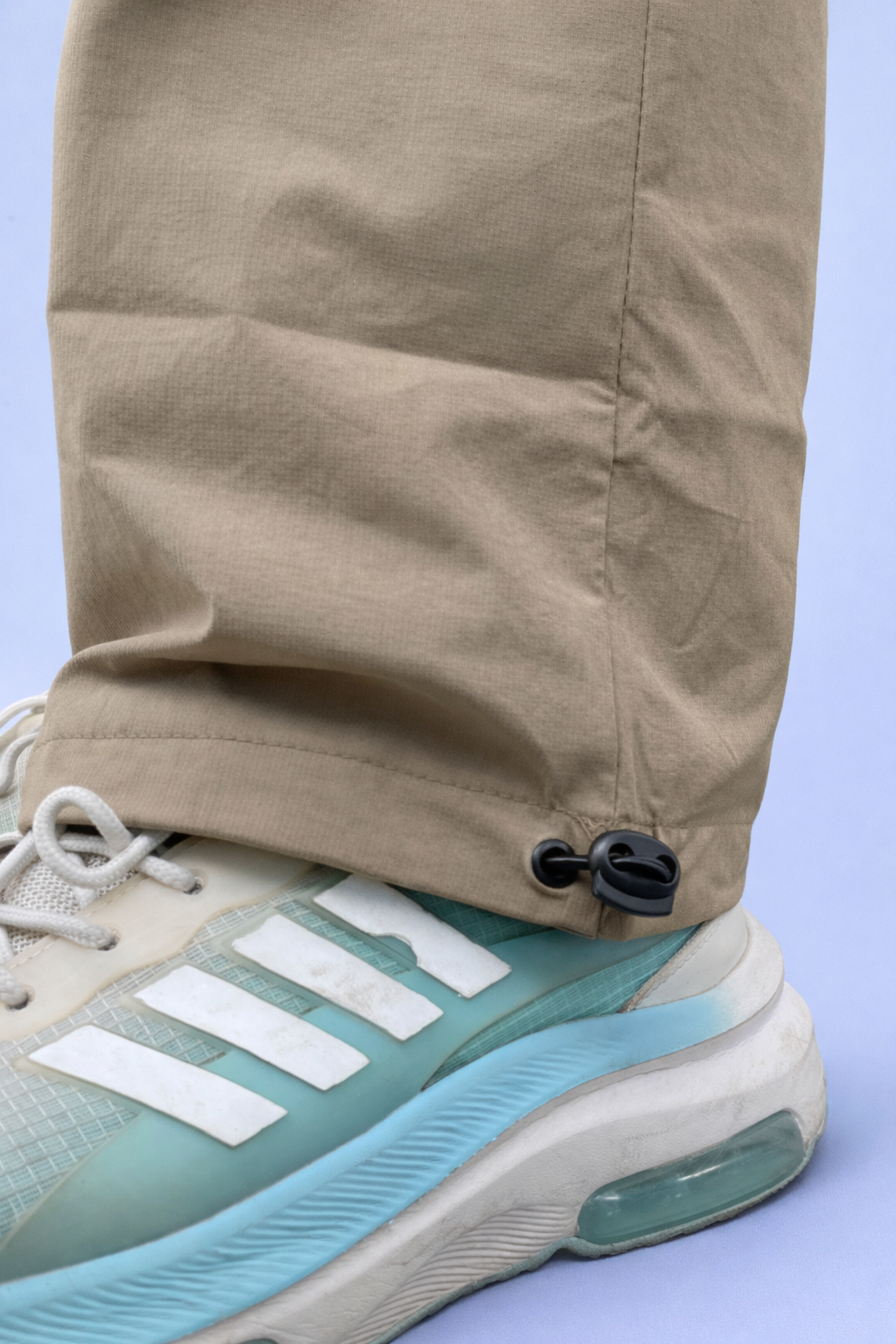 Beige jogger cuffs with adjustable drawcord and elastic hem