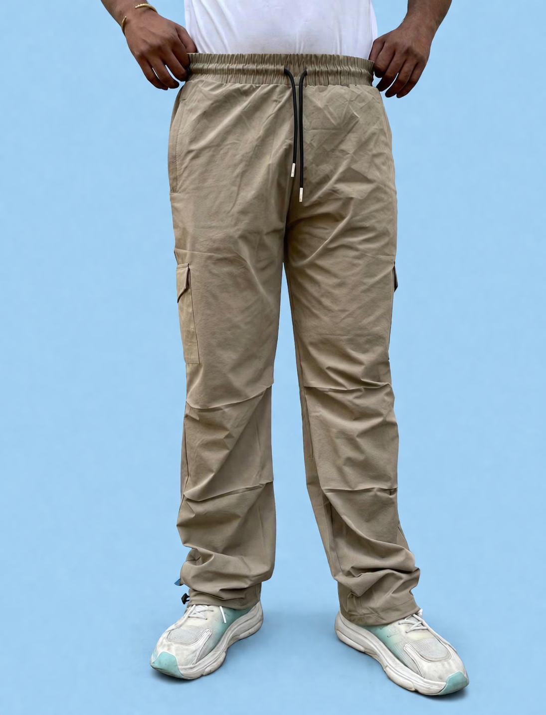 Beige cargo joggers with elastic waistband, drawstring, and side cargo pockets