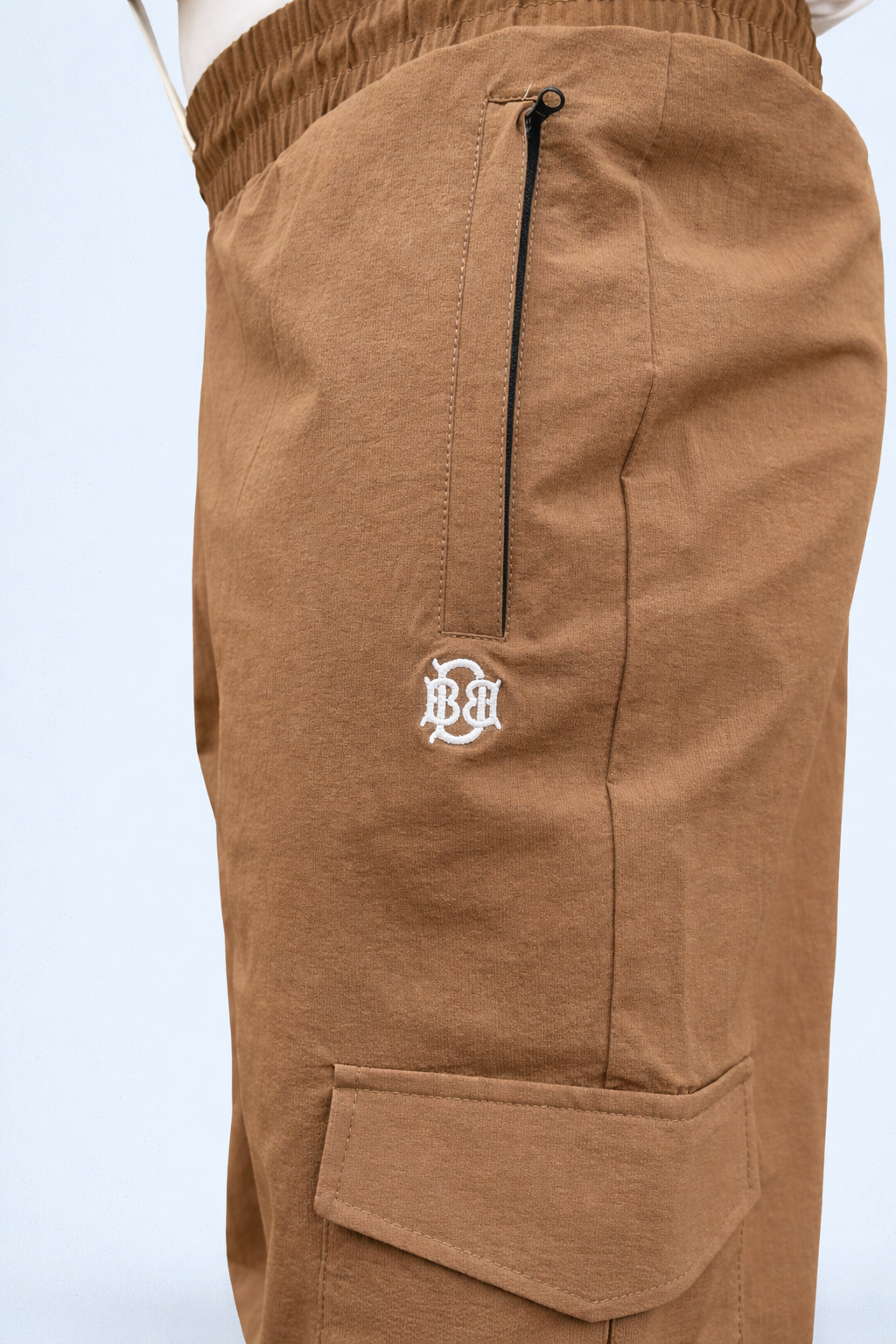 Brown cargo joggers with front leg zip pocket and stitched cargo seam details