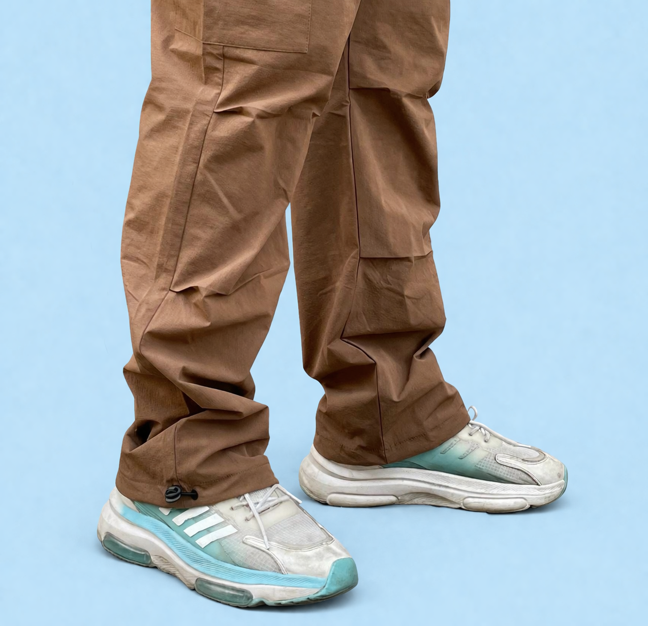 Brown cargo joggers with cargo pocket panels and ankle cuff drawcord in back view