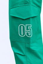 Green cargo joggers close-up: 05 number patch on cargo pocket