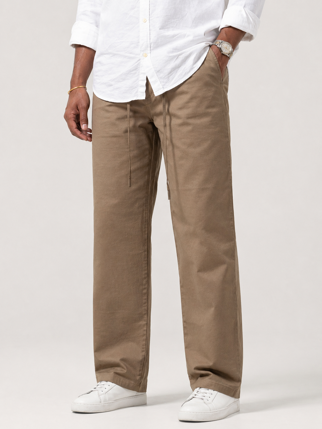 Brown relaxed trousers with drawstring waist and straight legs; side seam pockets