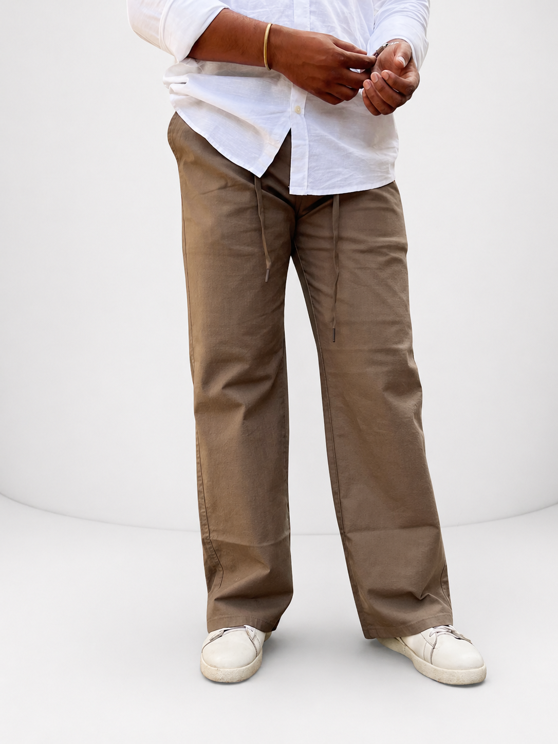 Brown drawstring casual pants with relaxed straight legs and side pockets