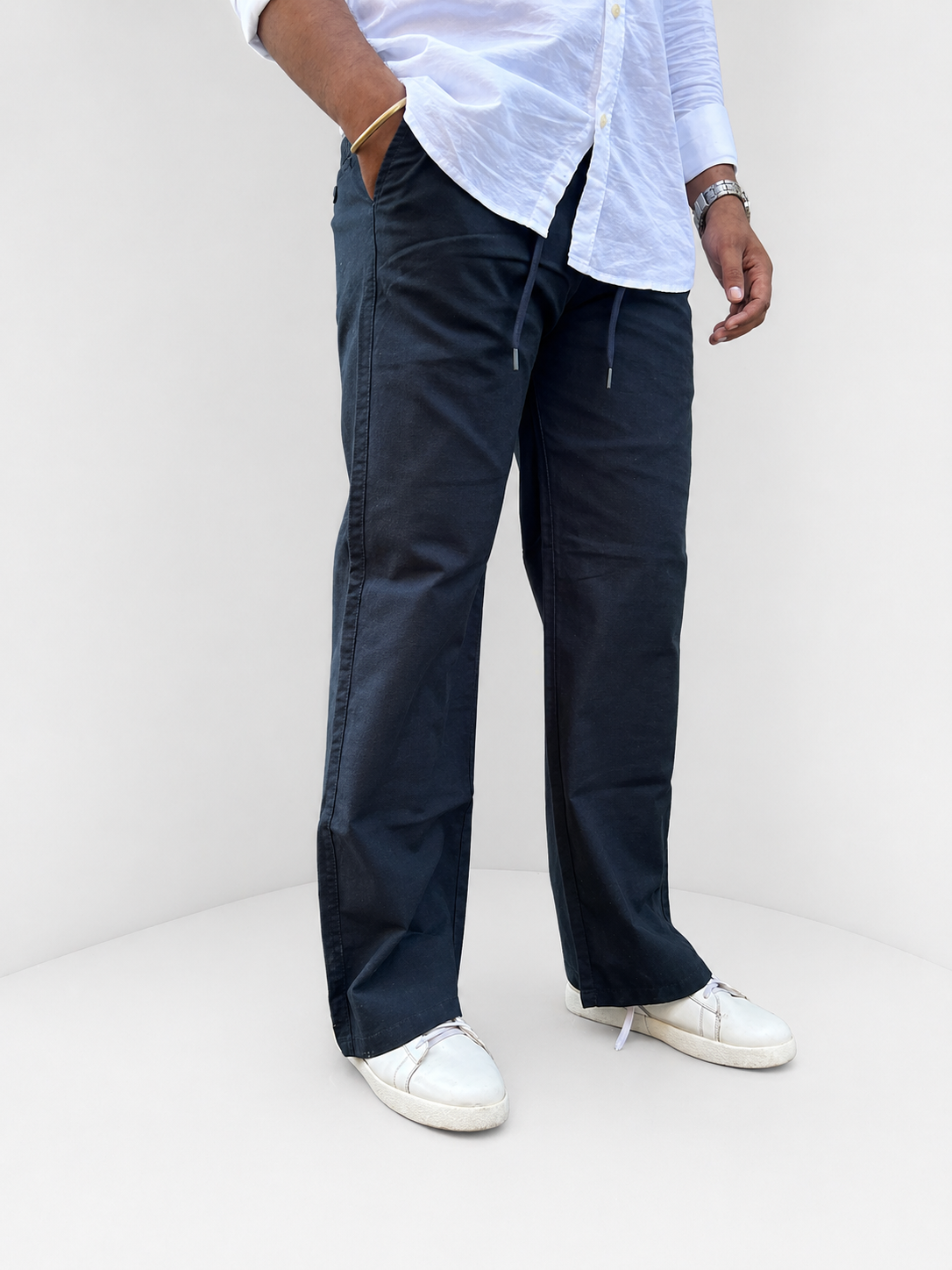 Navy drawstring trousers with adjustable tie, relaxed fit, hand-in-pocket view