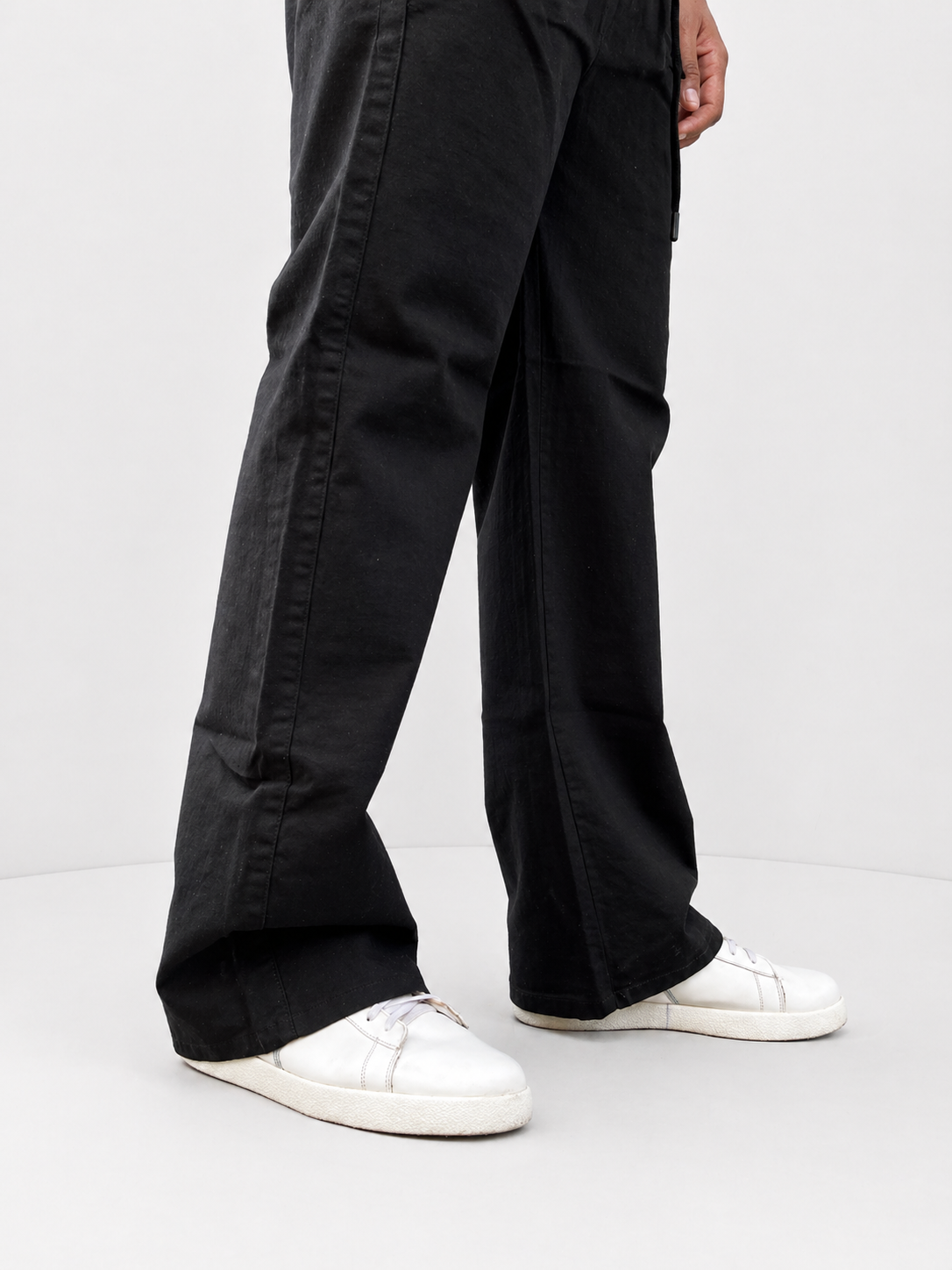Black linen-cotton trousers with front pleats, side seam detail, wide cuff hem