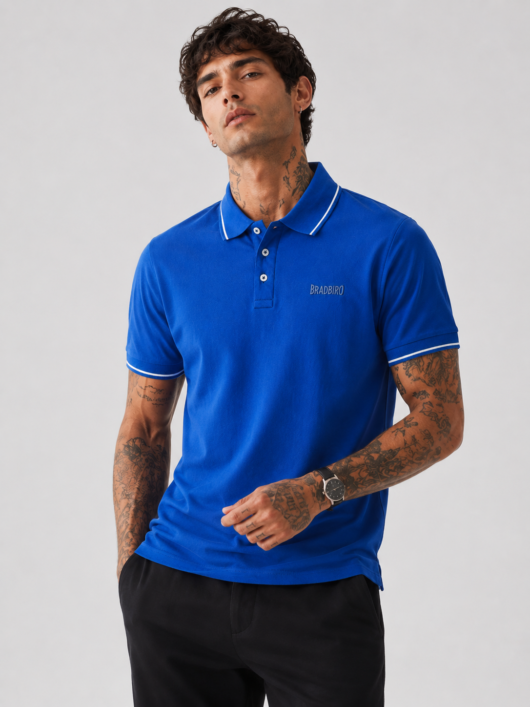 Blue polo shirt with Bradbird chest logo and white tipped collar, short sleeves