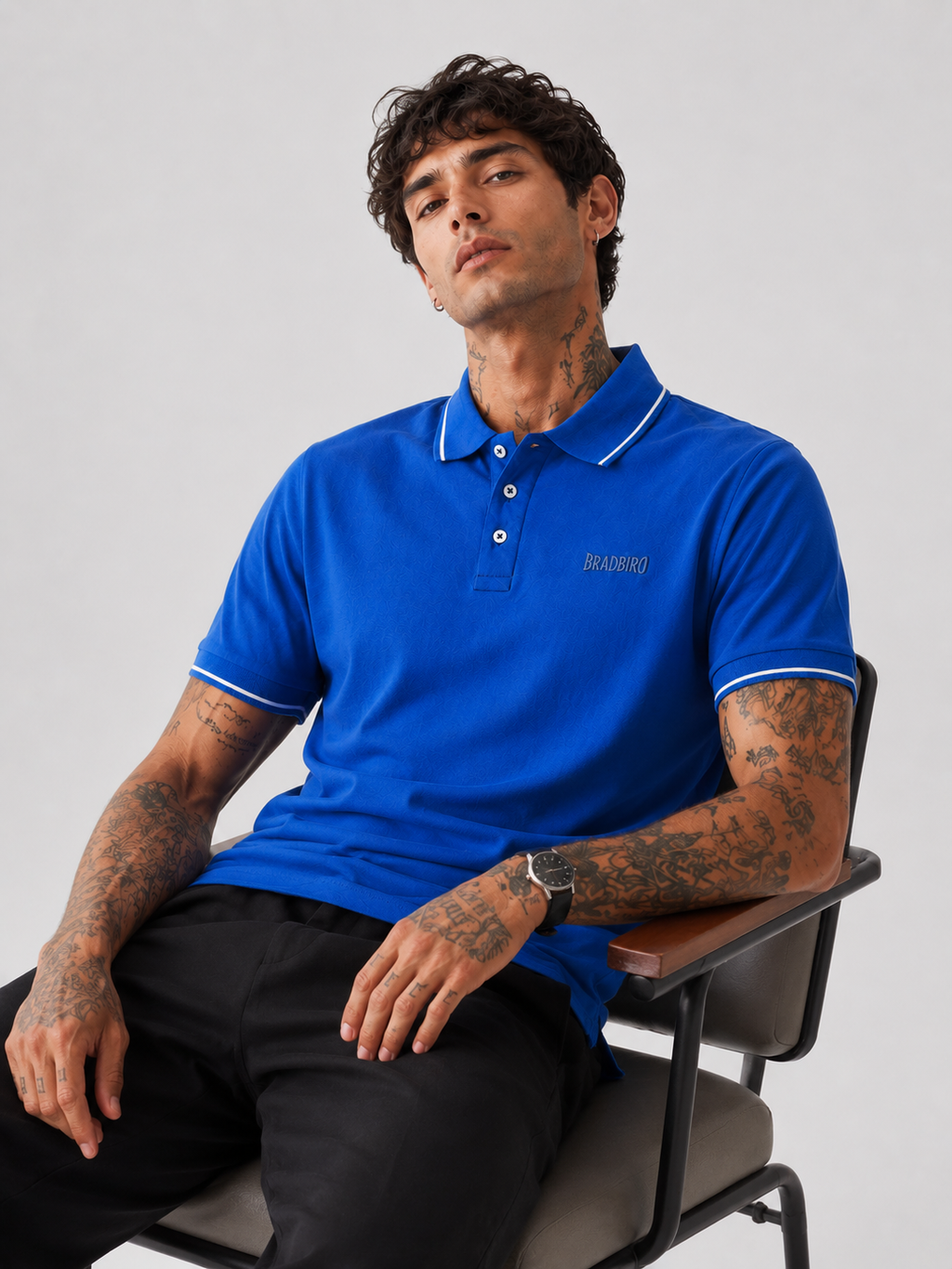 Blue Bradbird polo shirt with white collar tipping and three-button placket