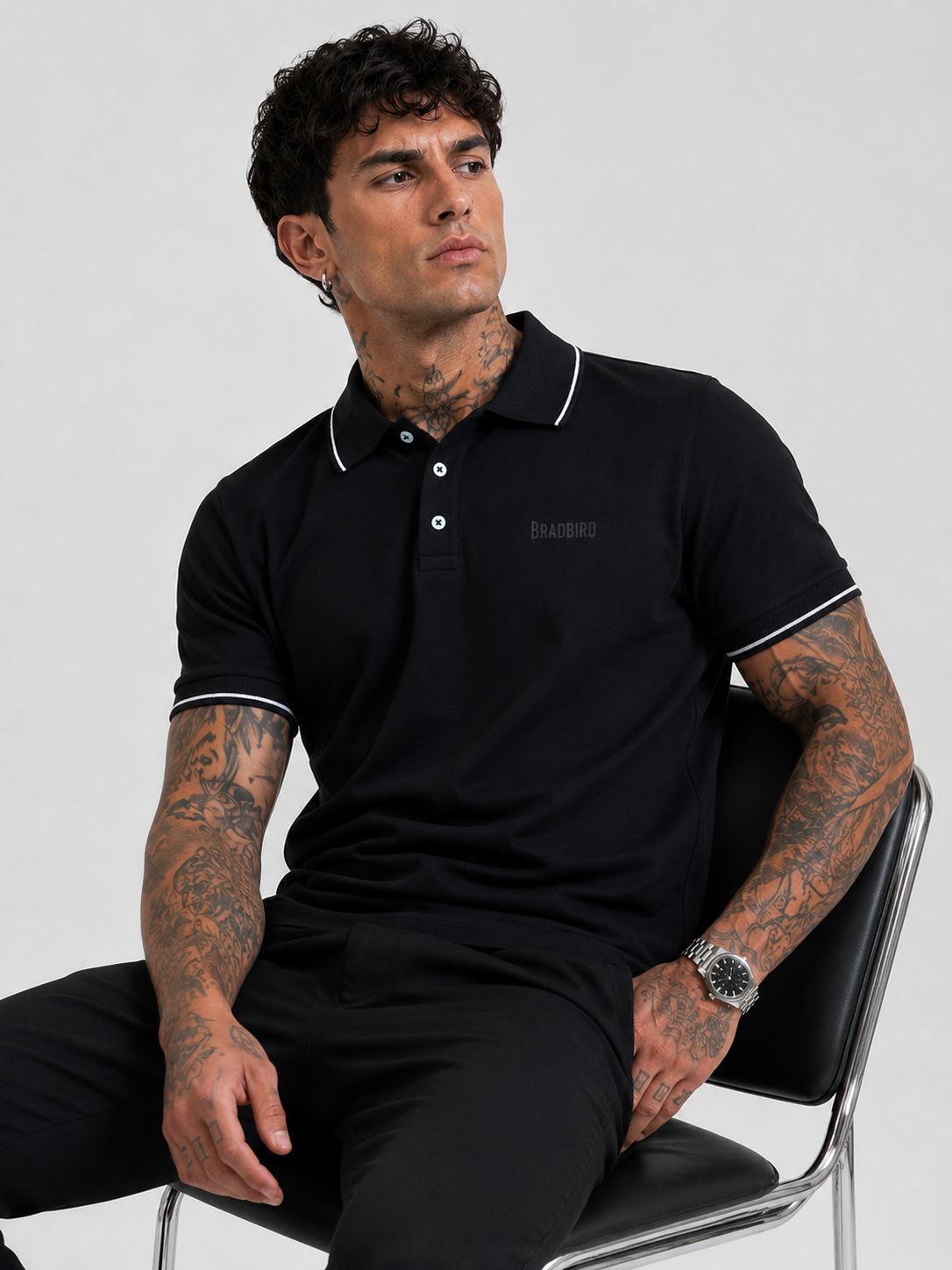 Men's black Bradbird polo T-shirt with white dual-tipping collar and button placket.