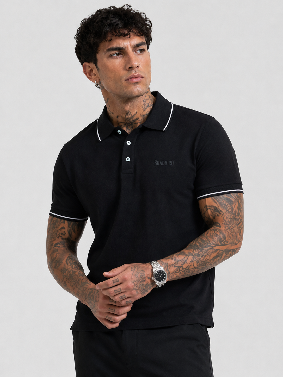 Men's black polo T-shirt with white-tipped sleeves, 3-button placket, Bradbird logo.