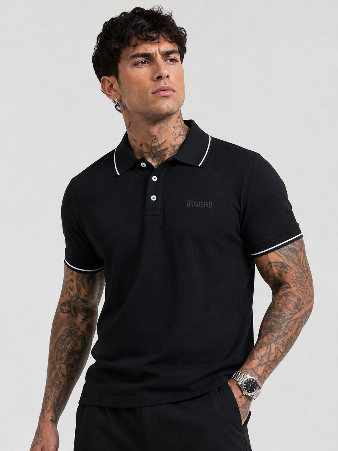 Black Bradbird polo T-shirt with white collar edging and neatly finished sleeve cuffs.