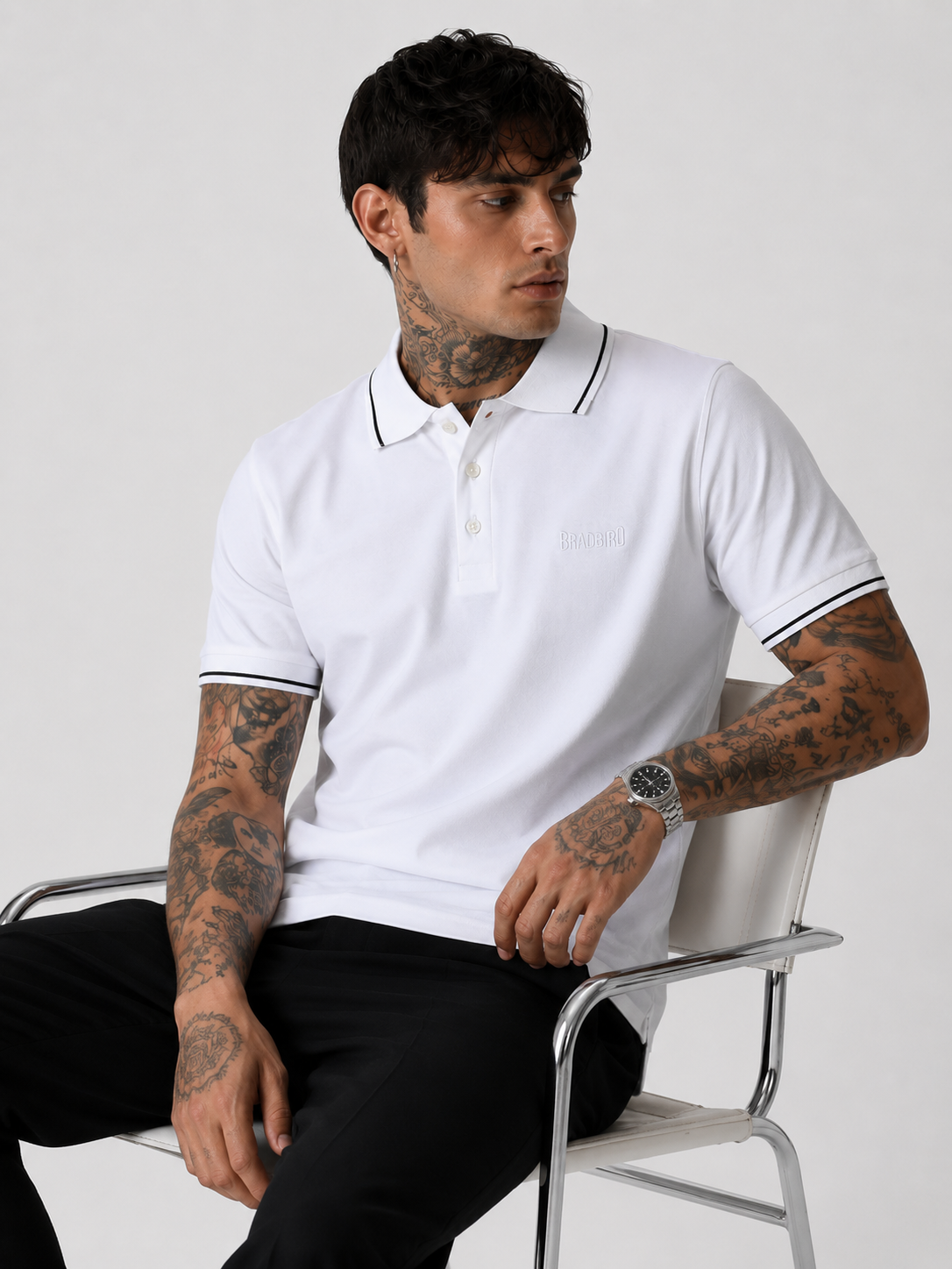 White polo shirt worn with black-trim collar and sleeve cuffs, short sleeves and button placket.