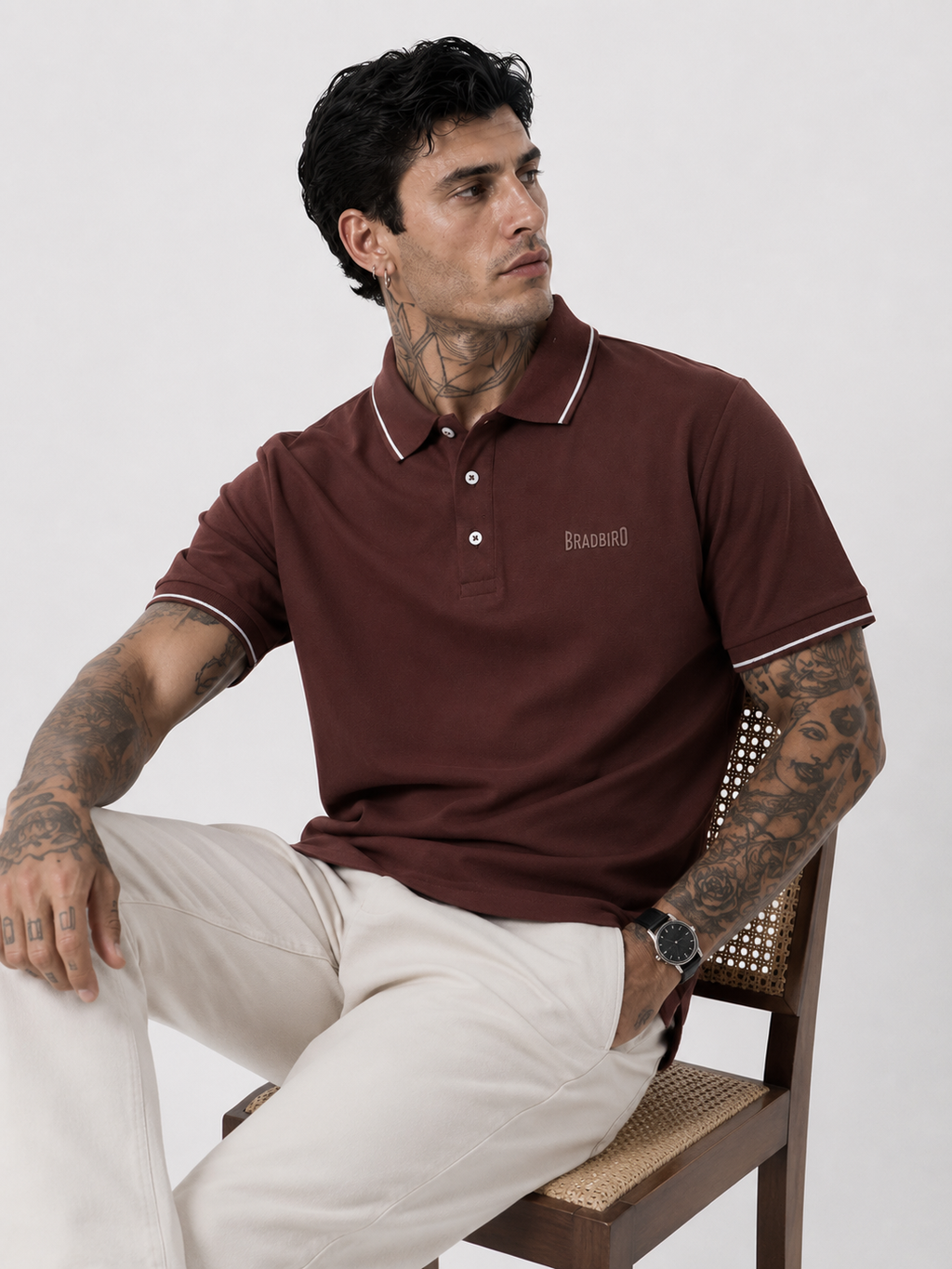 Coffee brown polo shirt with white contrast collar and sleeve trim, model seated.