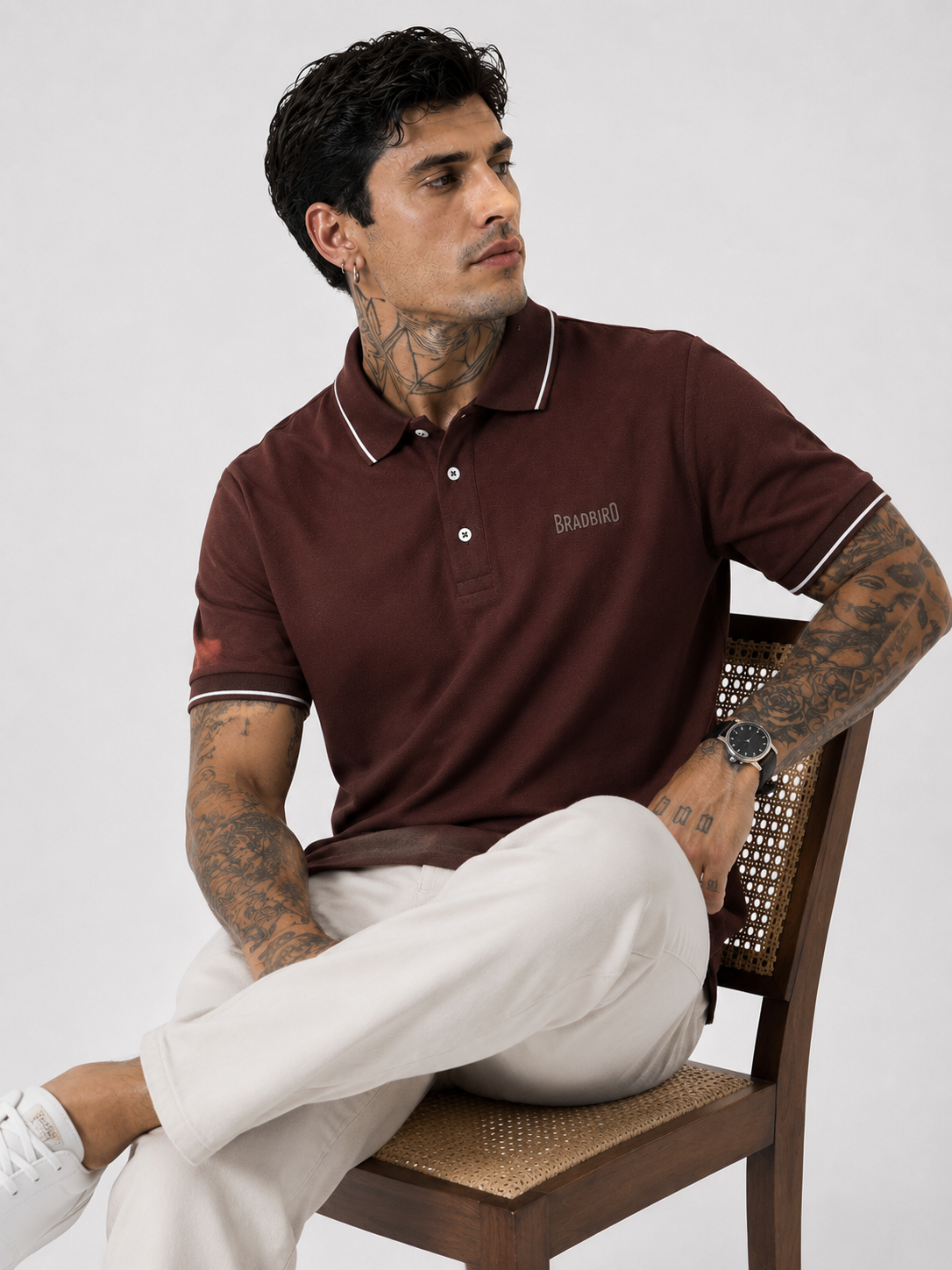 Coffee brown polo shirt with white contrast collar tips and short sleeves, model kneeling.