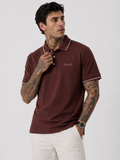 Coffee brown polo shirt on model with white contrast collar trim and Bradbird chest logo.