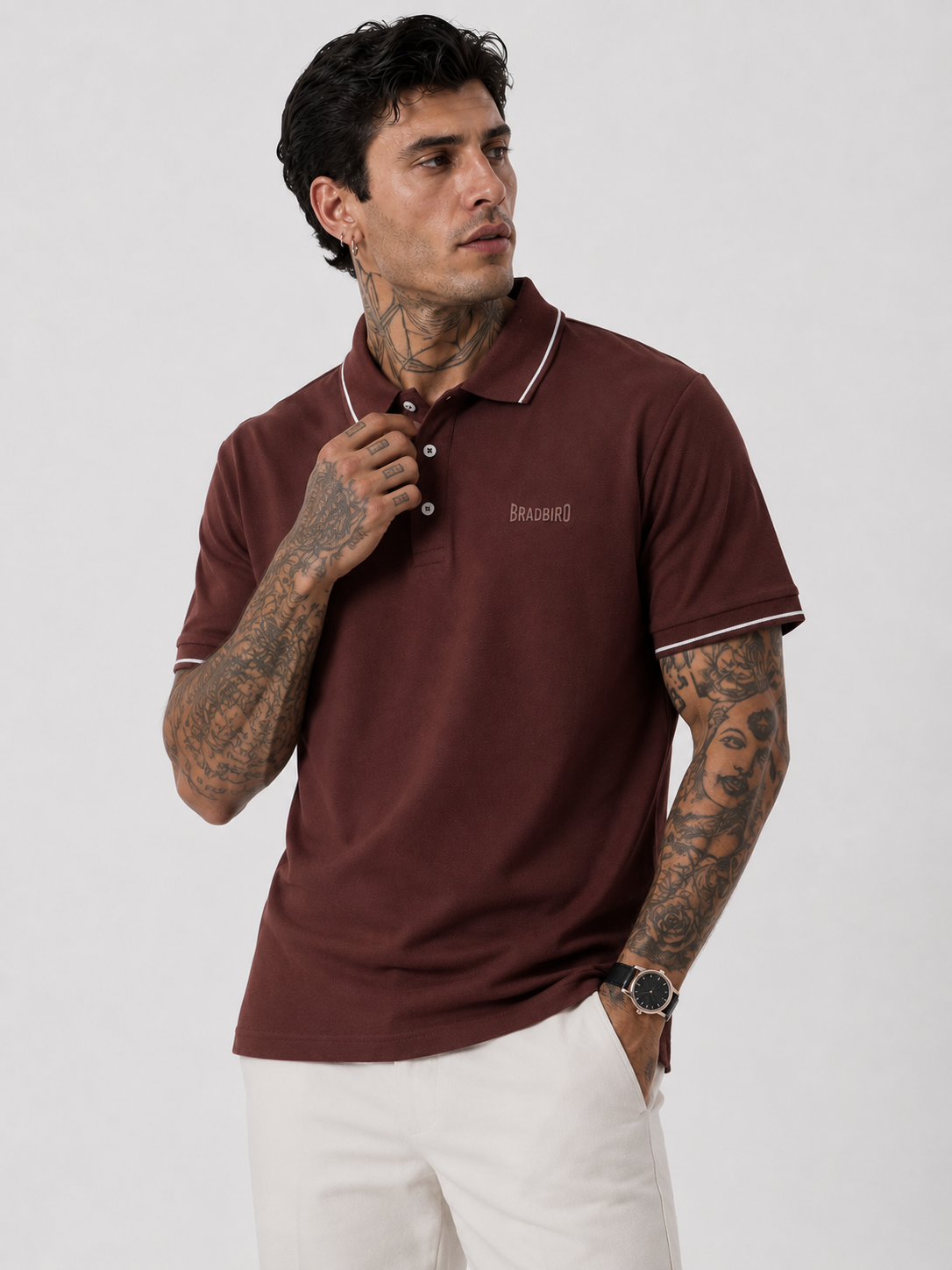 Coffee brown polo shirt on model with white contrast collar trim and Bradbird chest logo.