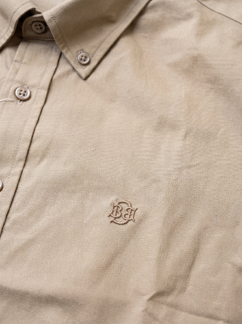 Khaki textured button-up shirt with tonal monogram on chest and button placket