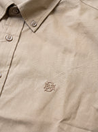 Khaki textured button-up shirt with tonal monogram on chest and button placket