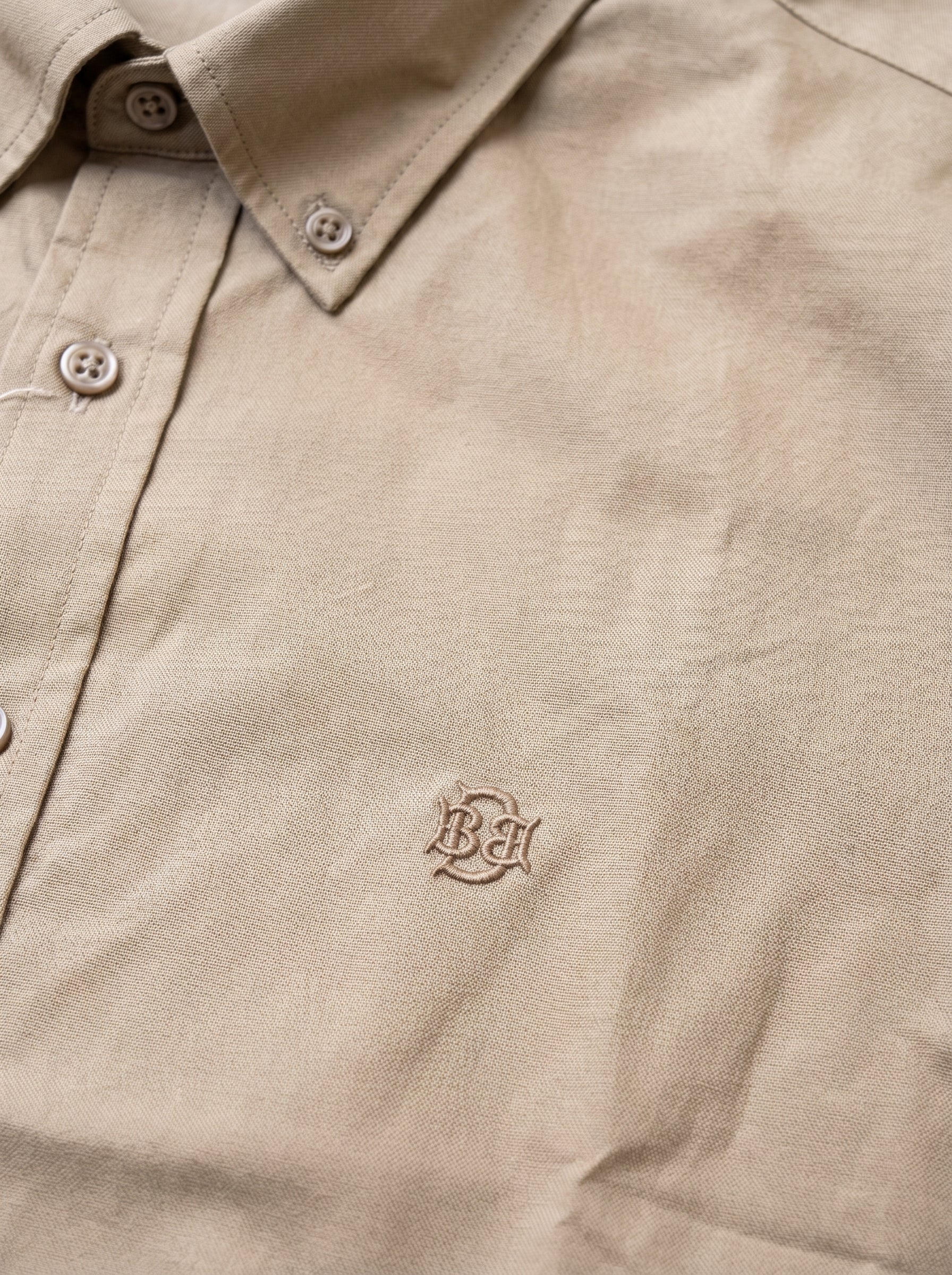 Khaki textured button-up shirt with tonal monogram on chest and button placket
