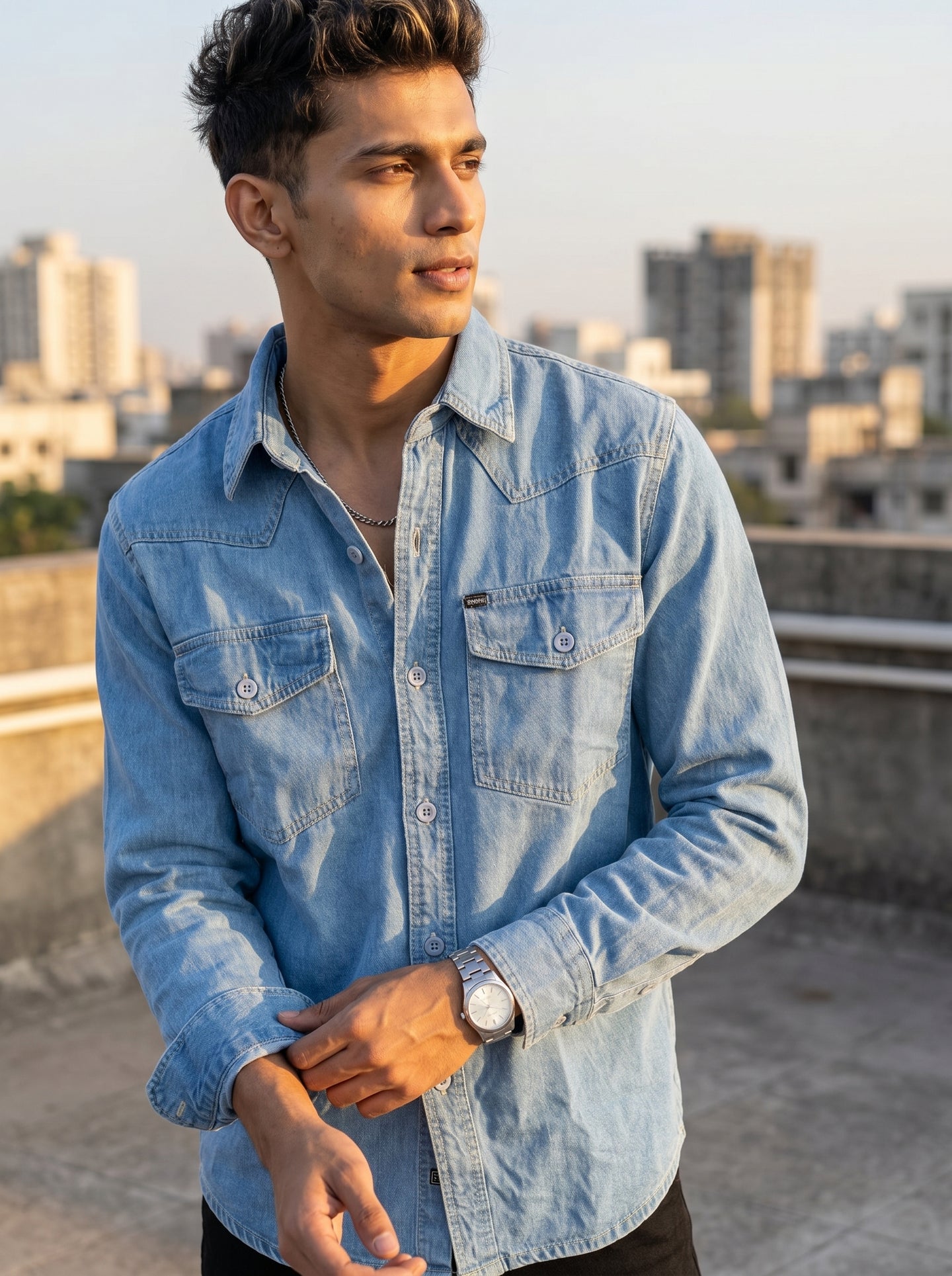 Light blue denim shirt with button front and two chest flap pockets