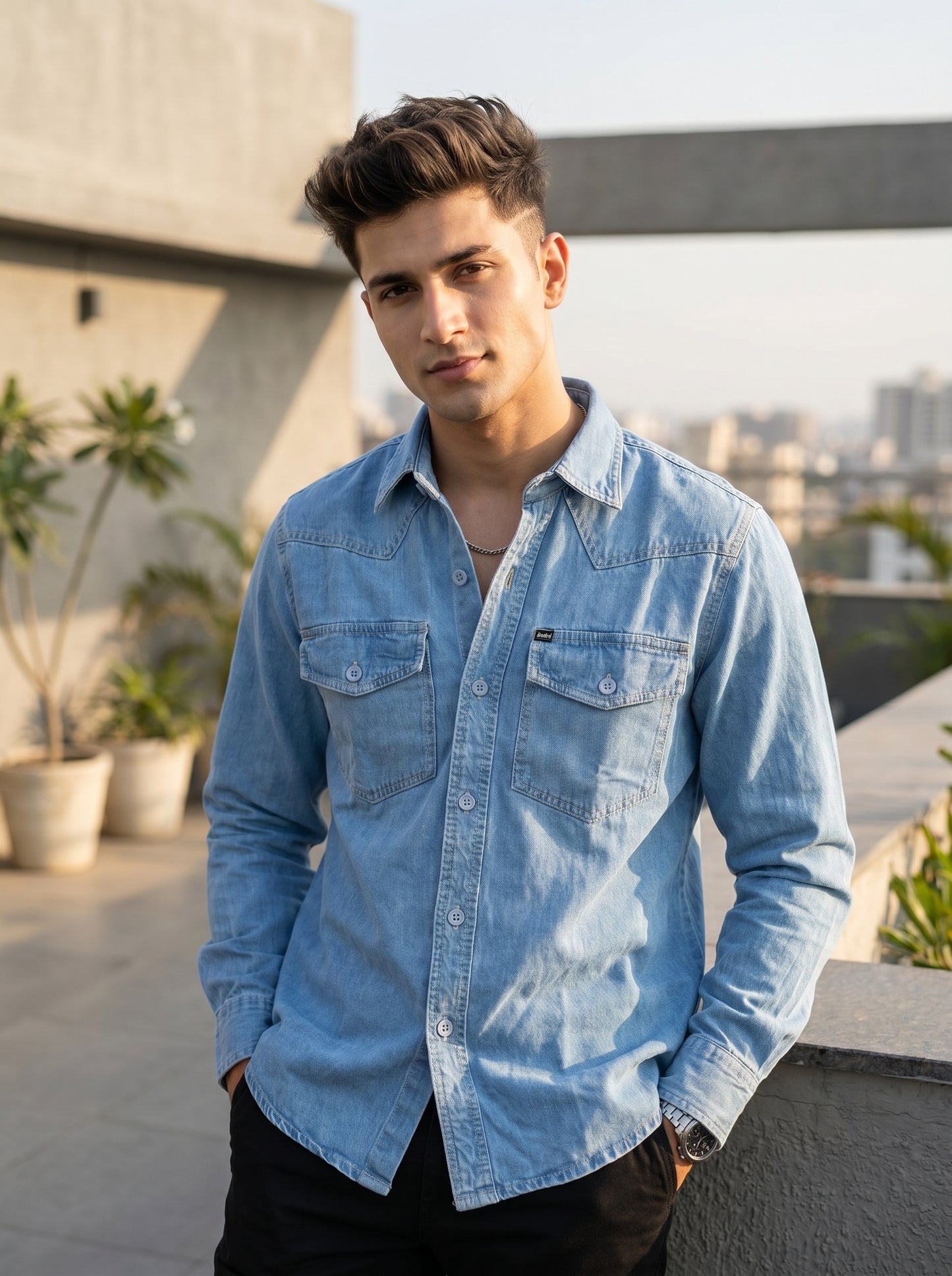 Light blue denim over-shirt with button front and two chest flap pockets