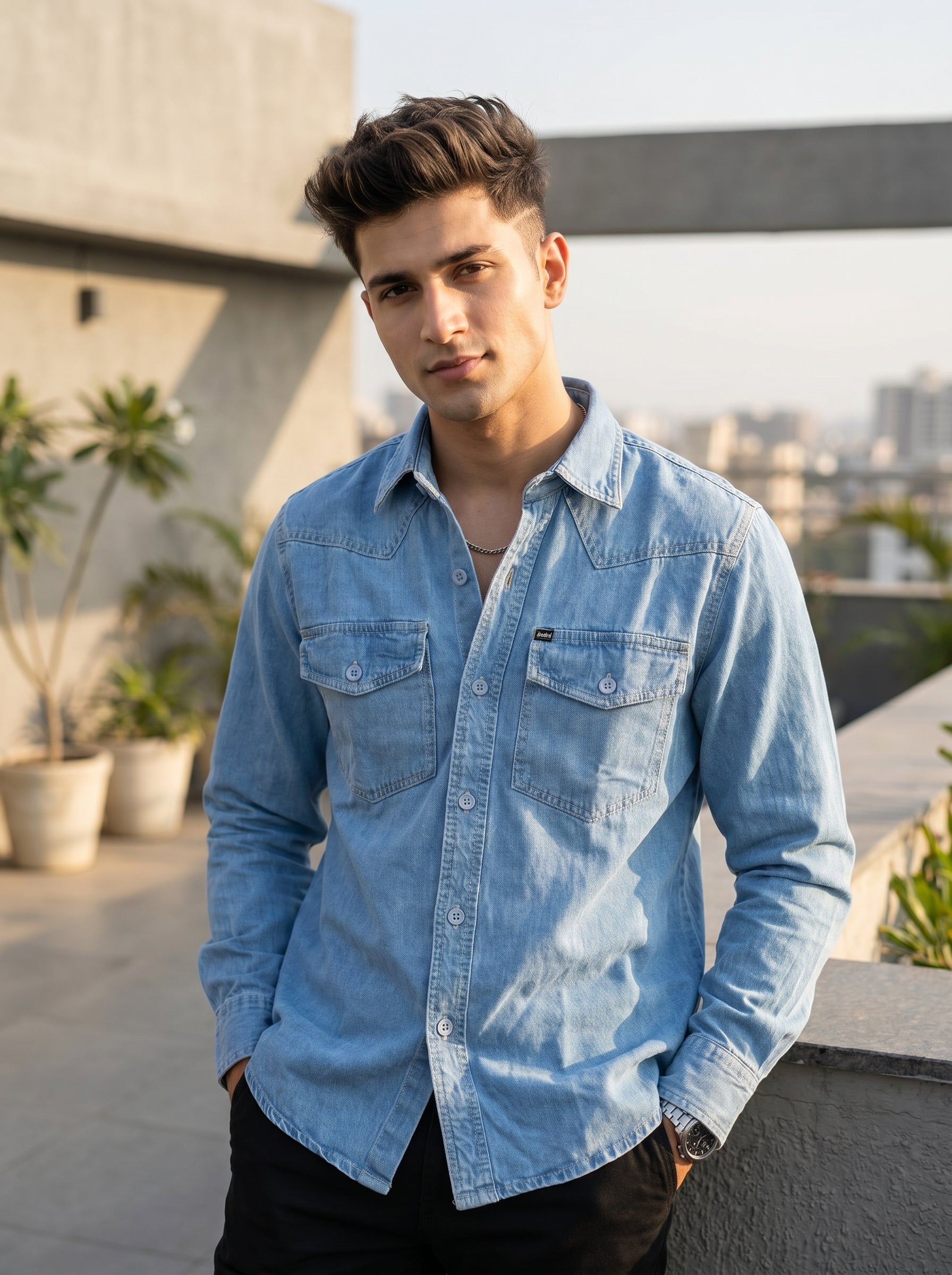 Light blue denim over-shirt with button front and two chest flap pockets