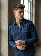 Blue denim western-style shirt with two flap chest pockets and button closures