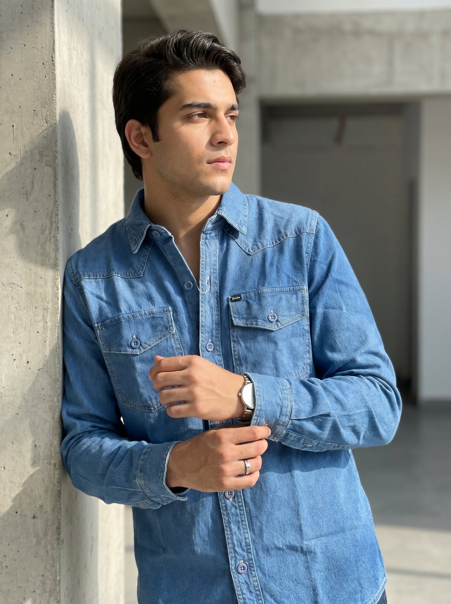 Medium wash denim western shirt with chest flap pockets and button front