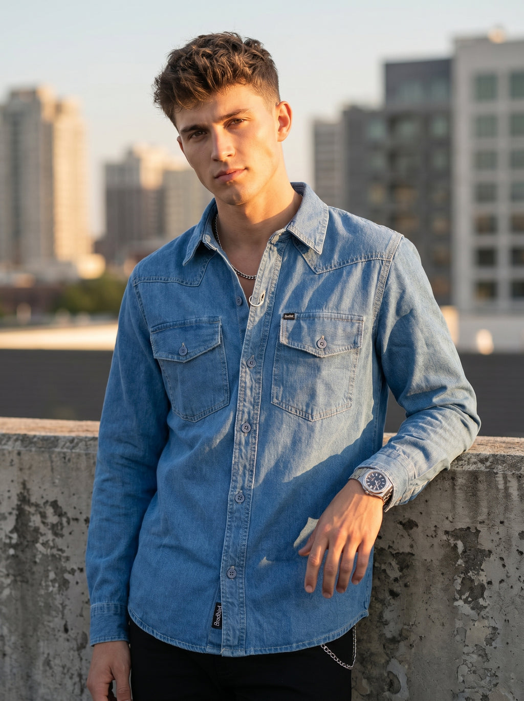 Medium wash denim western shirt with flap chest pockets and button front
