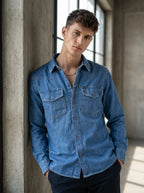 Medium wash denim western shirt with snap-button cuffs and chest flap pockets