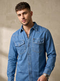 Medium wash denim western shirt with snap buttons and chest flap pockets