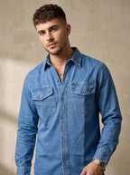 Medium wash denim western shirt with snap buttons and chest flap pockets
