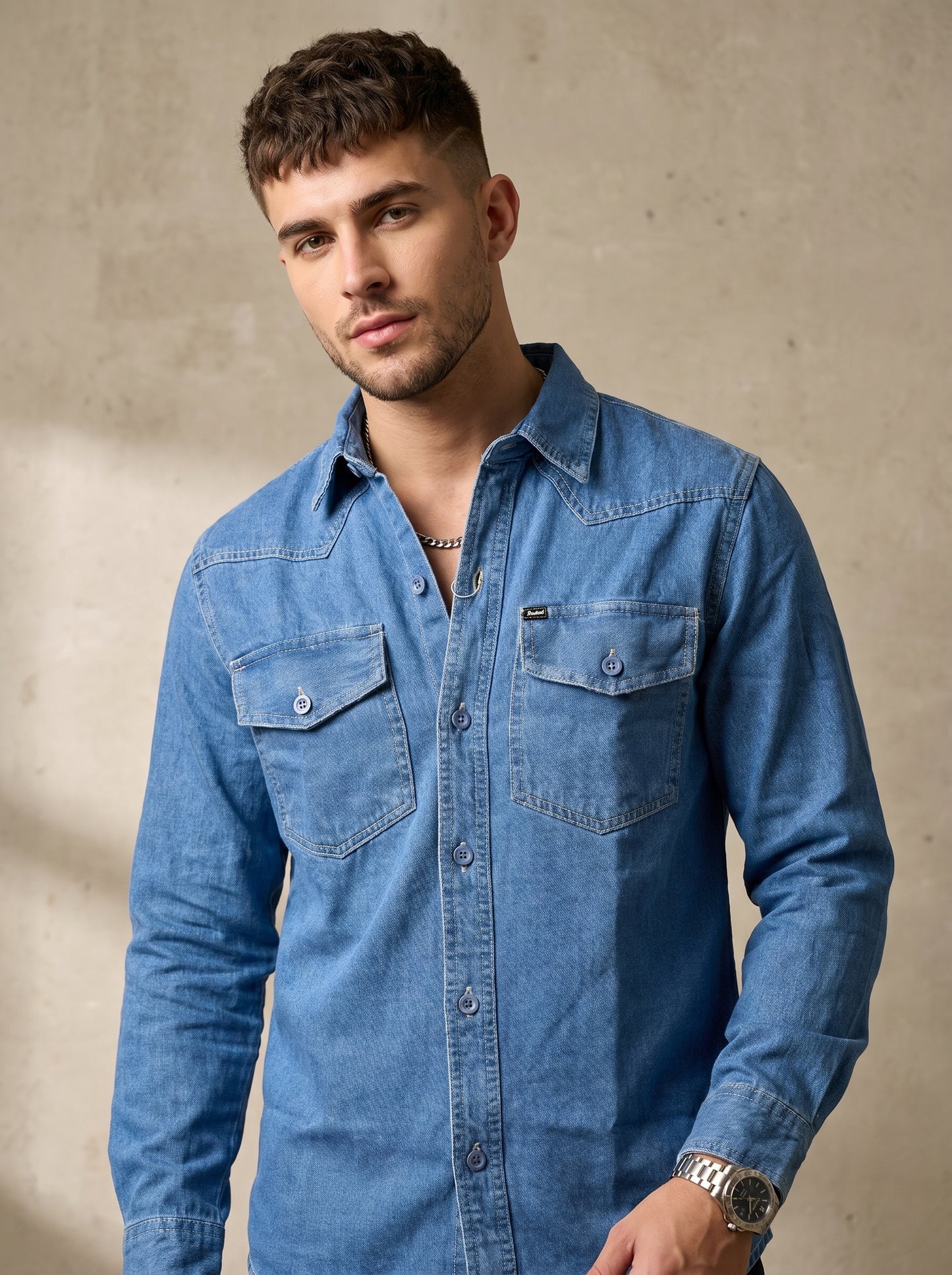 Medium wash denim western shirt with snap buttons and chest flap pockets