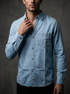 Light blue denim button-up shirt with chest pocket and long sleeves