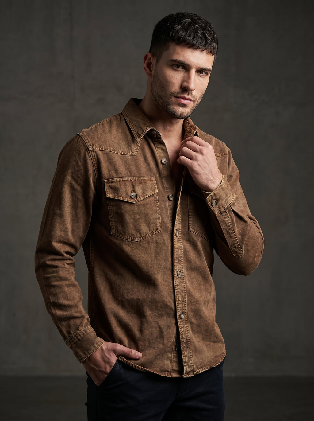 Brown denim western shirt with pointed collar, snap buttons, and chest pockets.