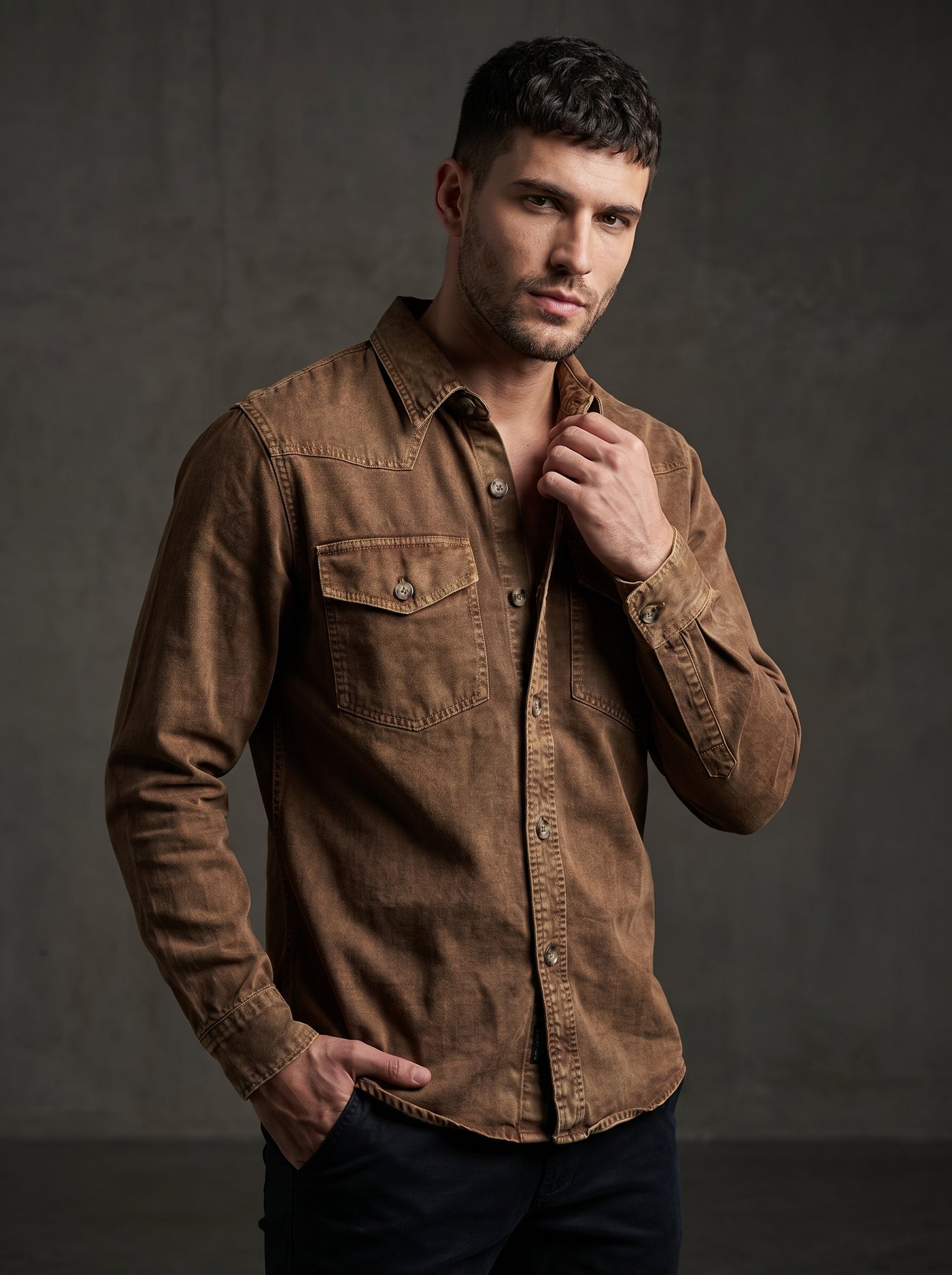 Brown denim western shirt with pointed collar, snap buttons, and chest pockets.