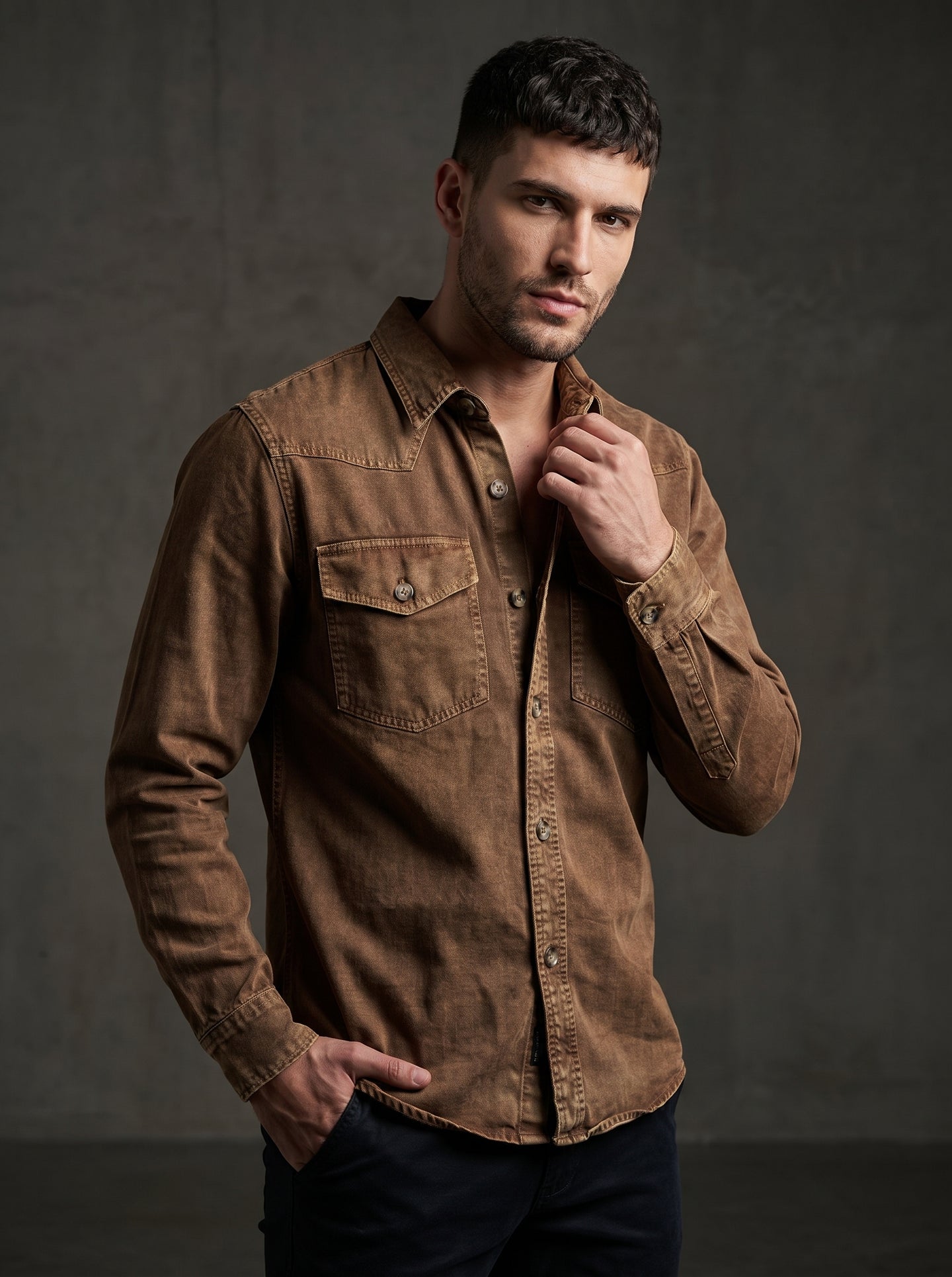 Brown denim western shirt with pointed collar, snap buttons, and chest pockets.
