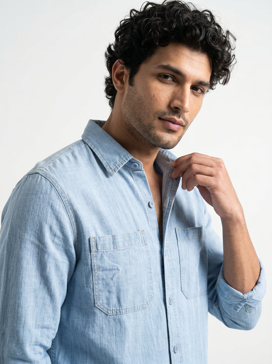 Men's light-wash denim shirt with point collar, button front, and chest patch pockets