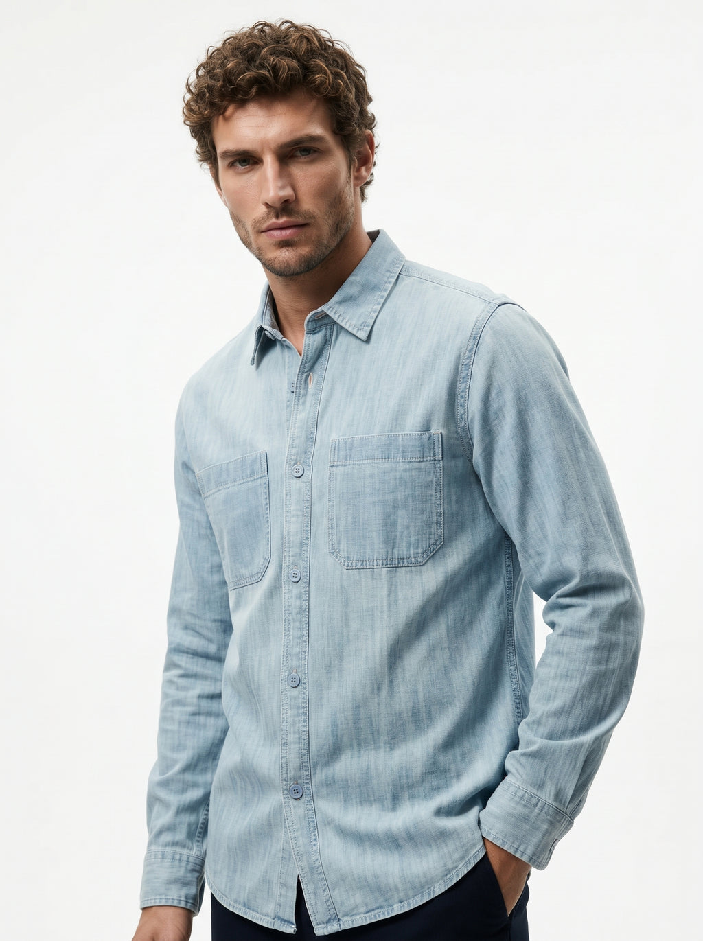 Light blue denim long-sleeve button-up shirt with chest pocket and curved hem