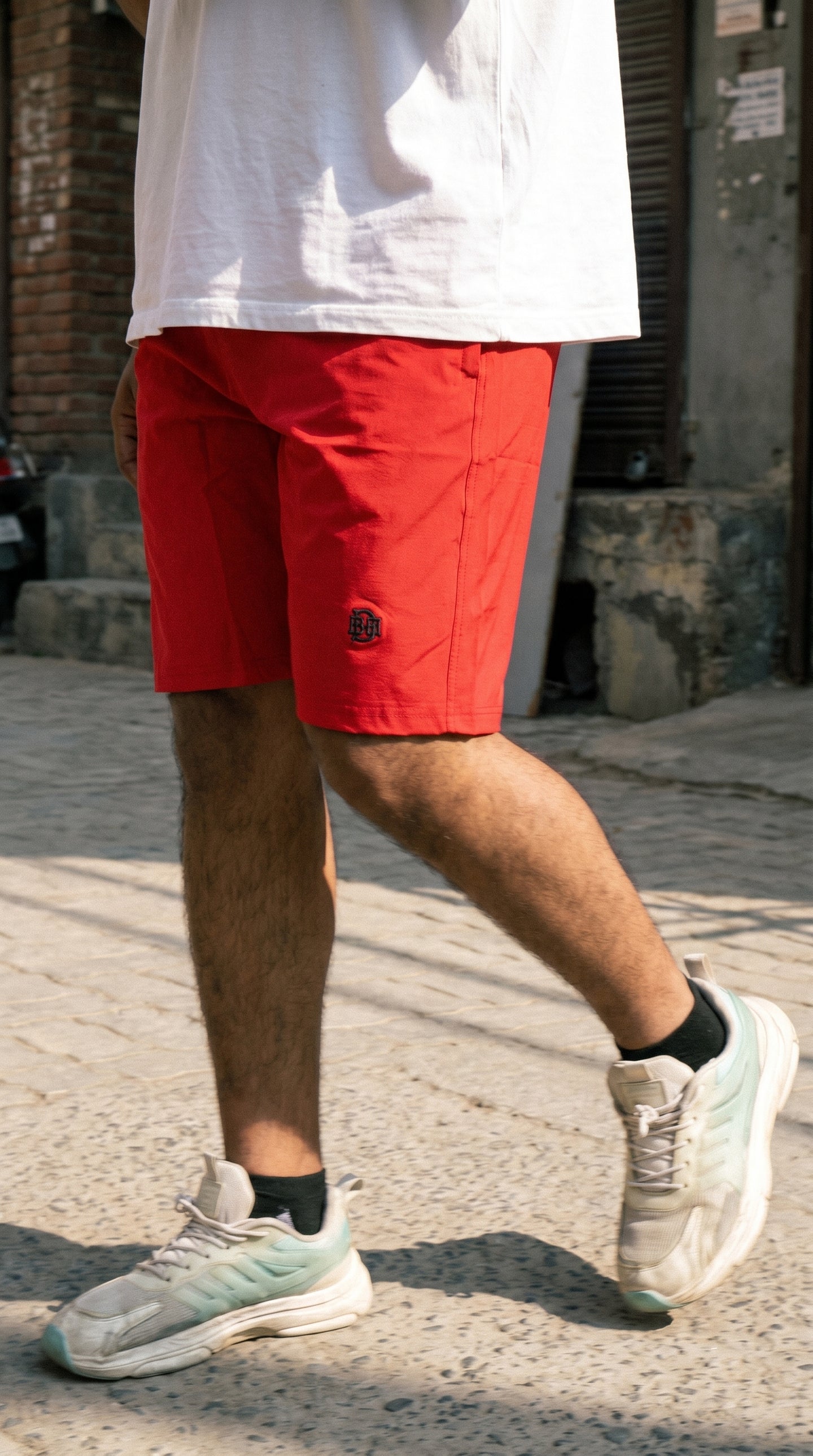 Red casual tech shorts, straight hem and small logo at lower thigh