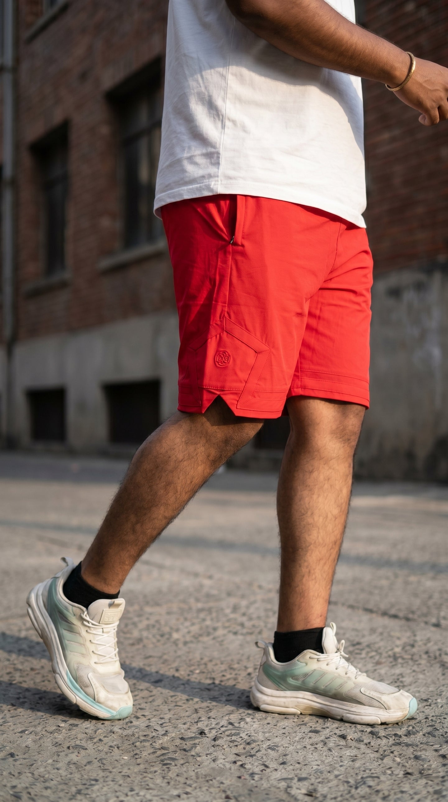 Red streetwear shorts with pentagonal back pocket, front drawstring waistband