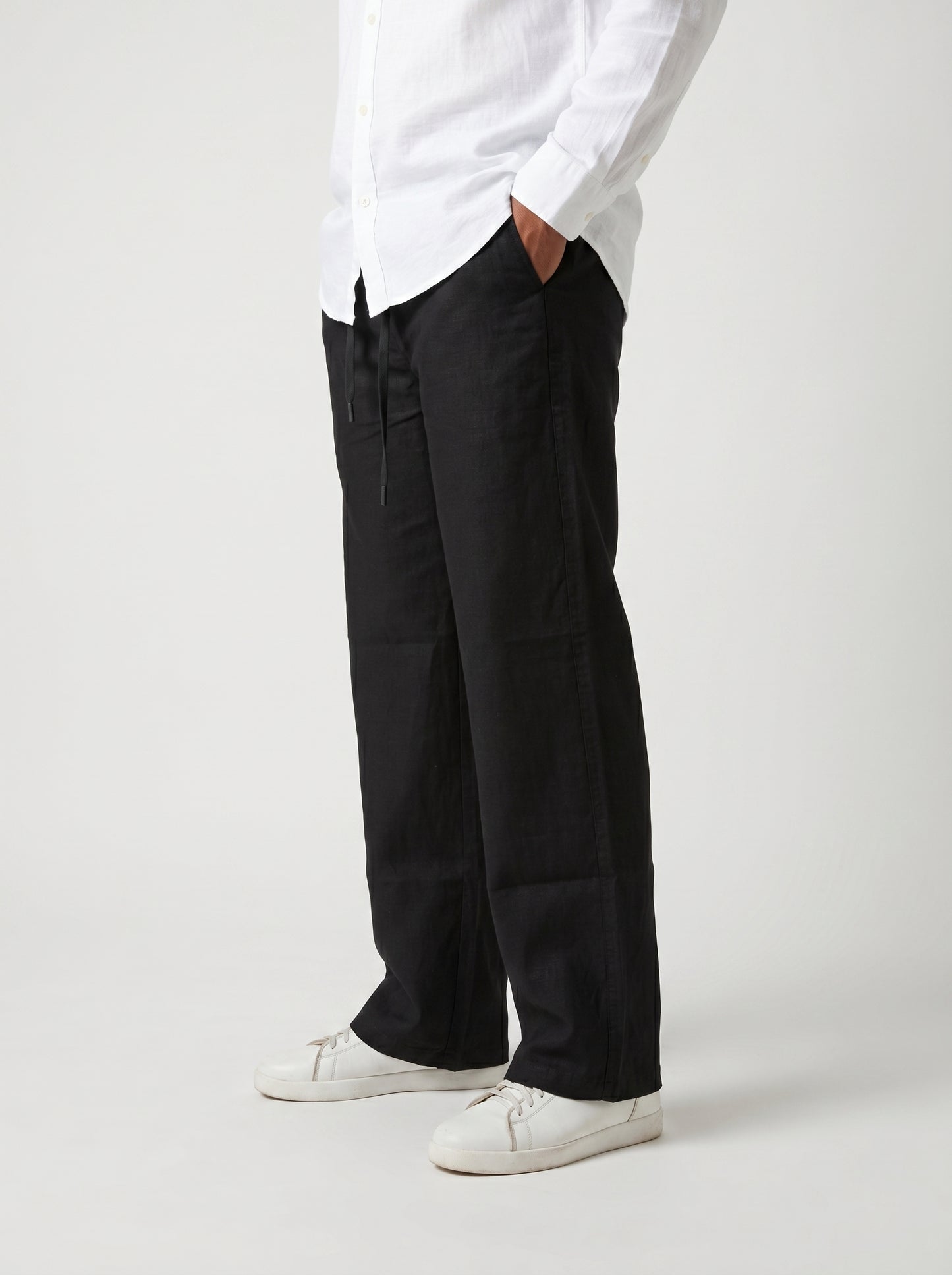 Black casual drawstring pants with roomy straight legs and gathered waistband